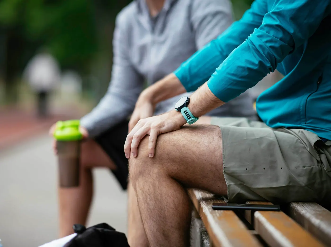 Two men talking on a park bench